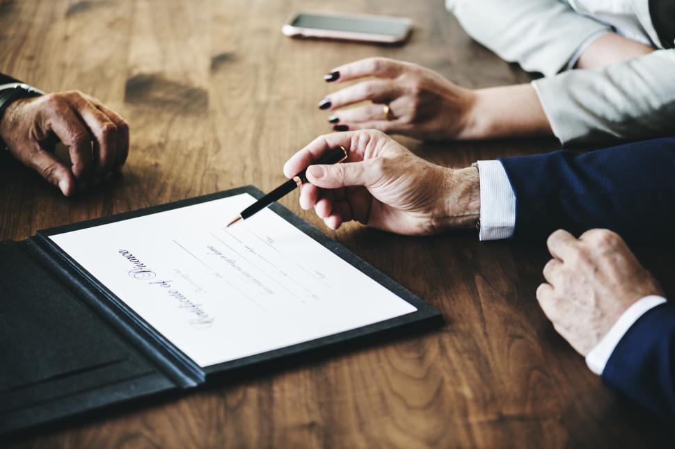 Free Image of Close up of a man preparing to sign the divorce certificate 