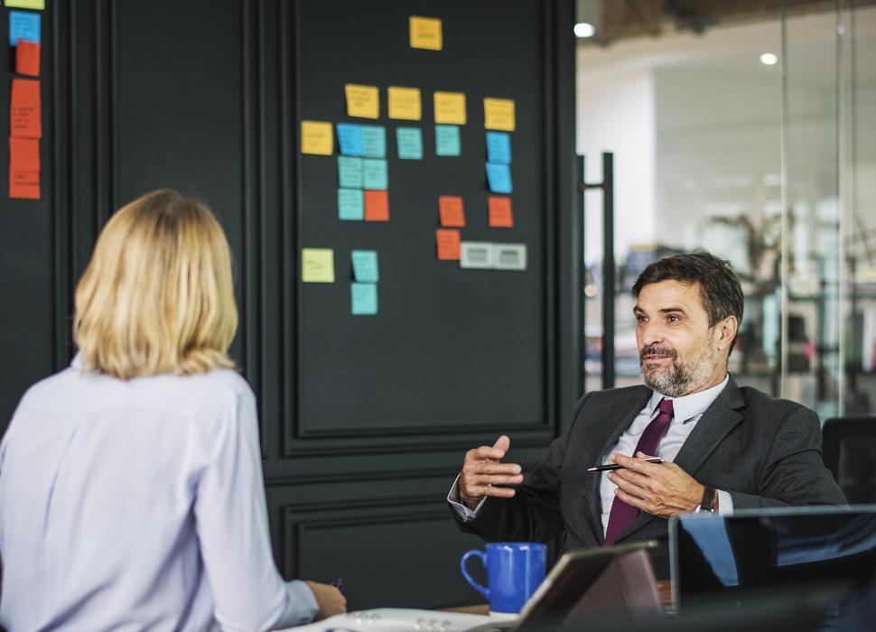 Free Image of A businessman in a meeting talking to a colleague 