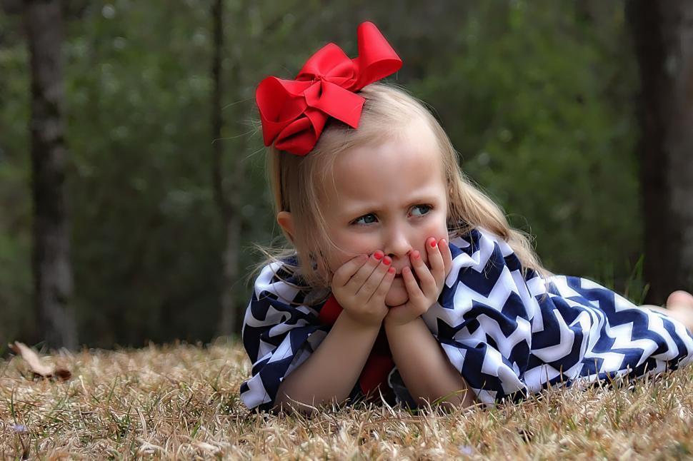 Free Image of Little Girl with Red Ribbon Bow on Hair 