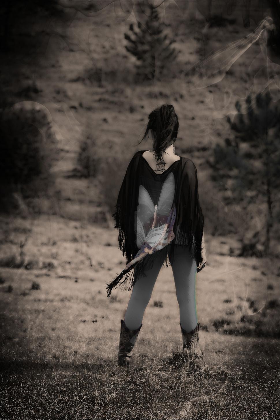 Free Image of Back View of Woman Standing on Grass Field 