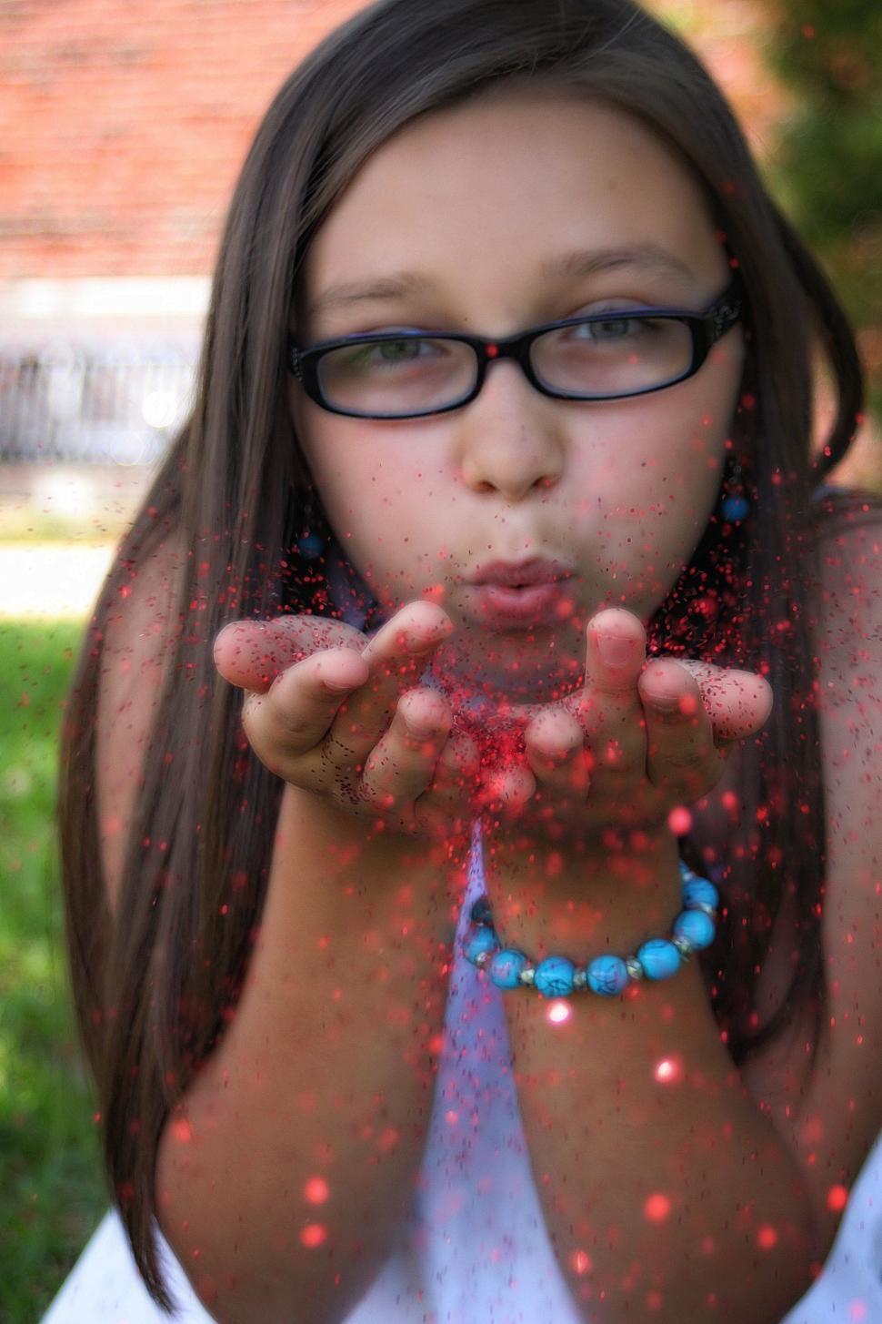 Free Image of Woman Blowing Red Glitter 