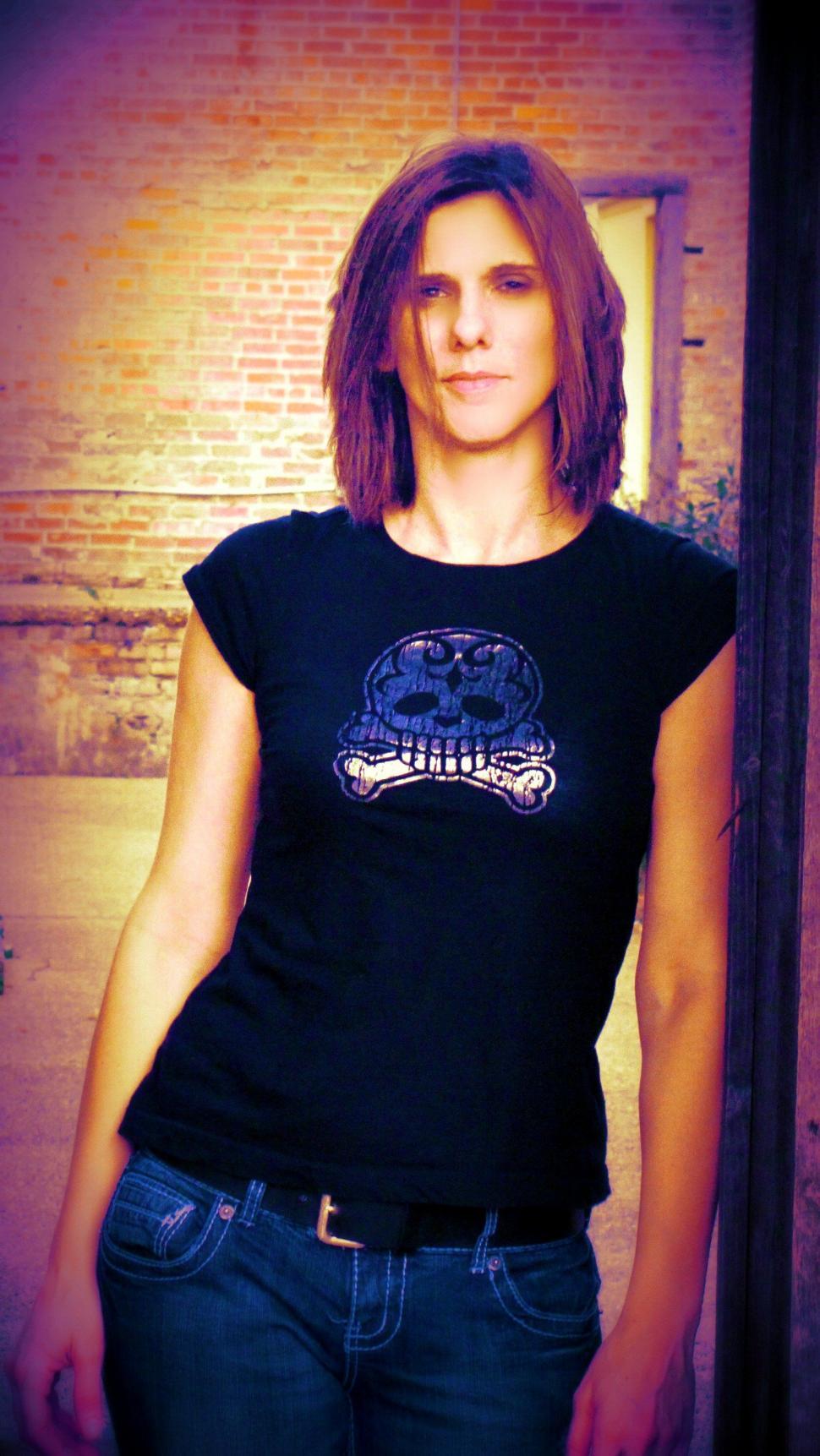 Free Image of Young Woman in crossbones t shirt 