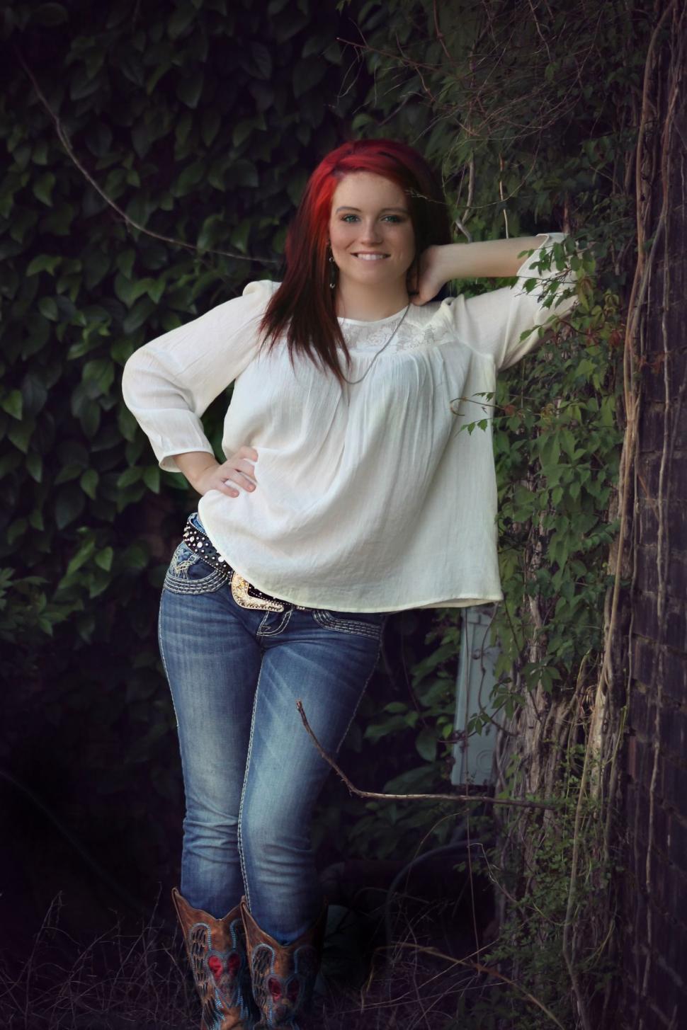 Free Image of Red Hair Woman Posing and Standing Against Tree  