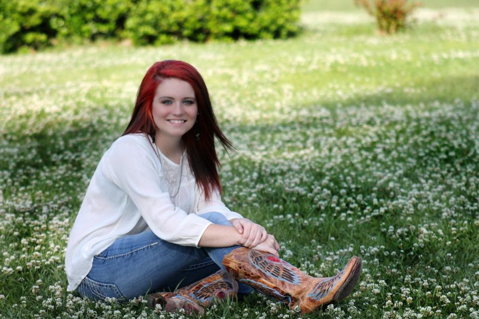 Free Image of Red Hair Woman posing in the park - looking at camera  