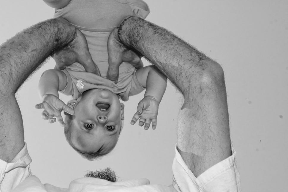 Free Image of Young Man Hands Lifting his daughter  
