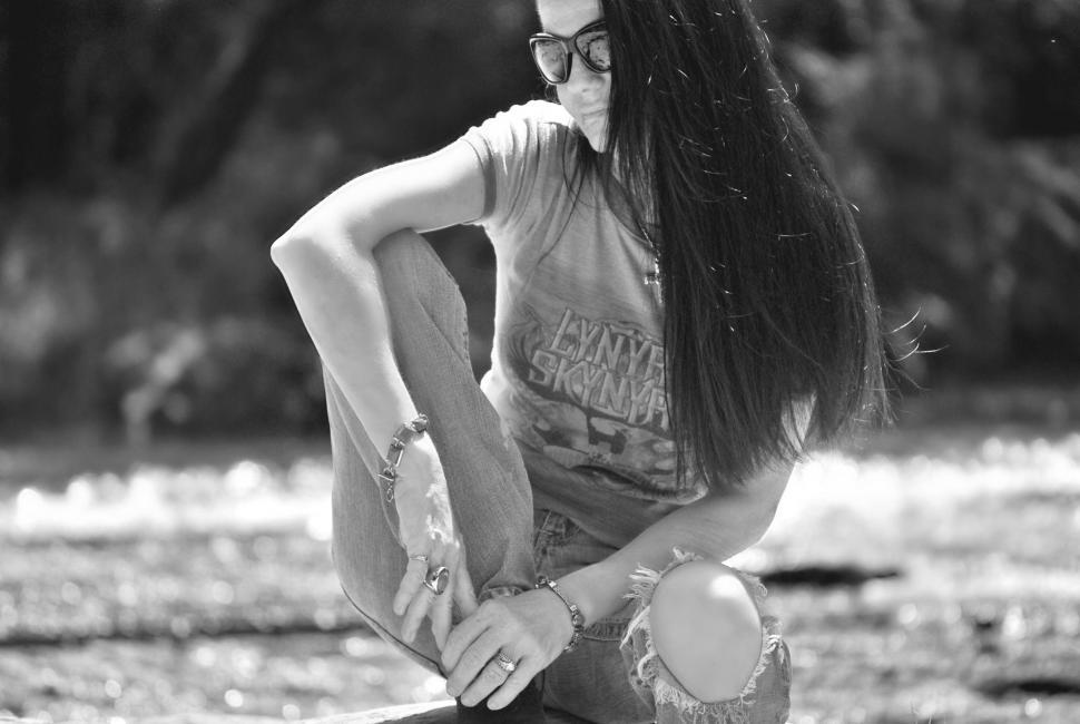 Free Image of Woman sitting on rock at lake-shore - looking down  