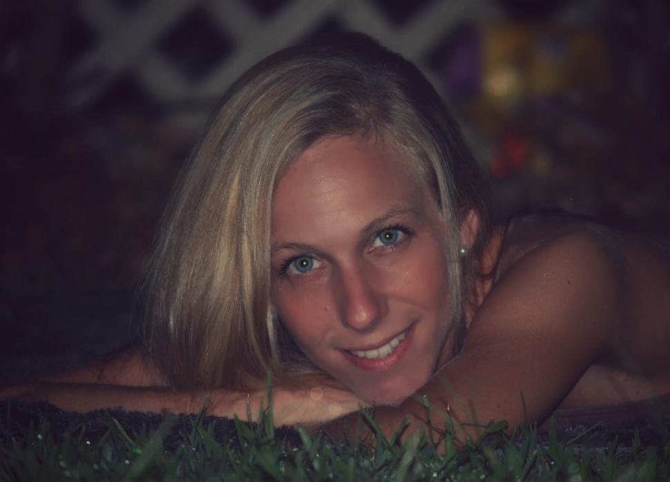 Free Image of Young Woman With Blonde Hair On Green Grass  