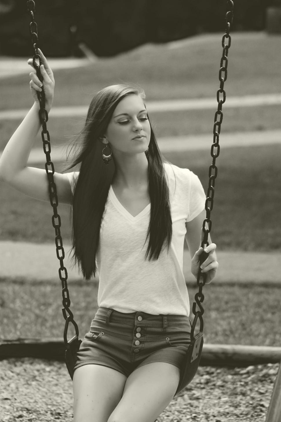 Free Image of Portrait of Young Woman Sitting on Swing  