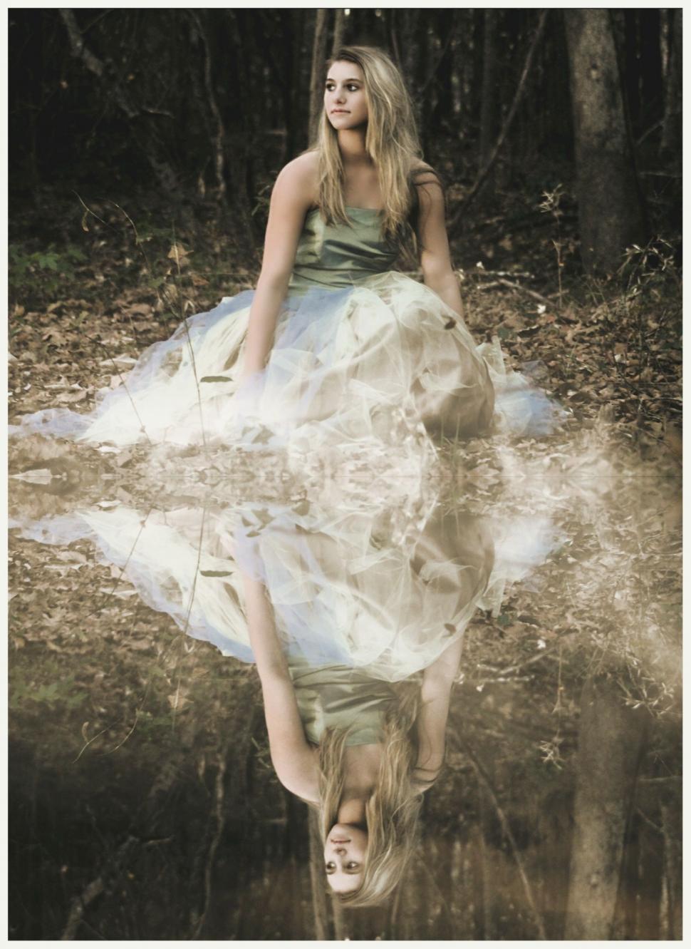 Free Image of Young Girl in Wedding Gown With Reflection in Lake 