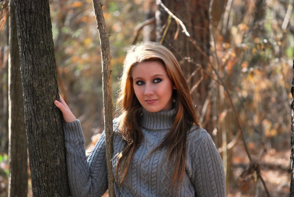 Free Image of Stylish Woman Standing With Hand on Tree - Looking at camera  