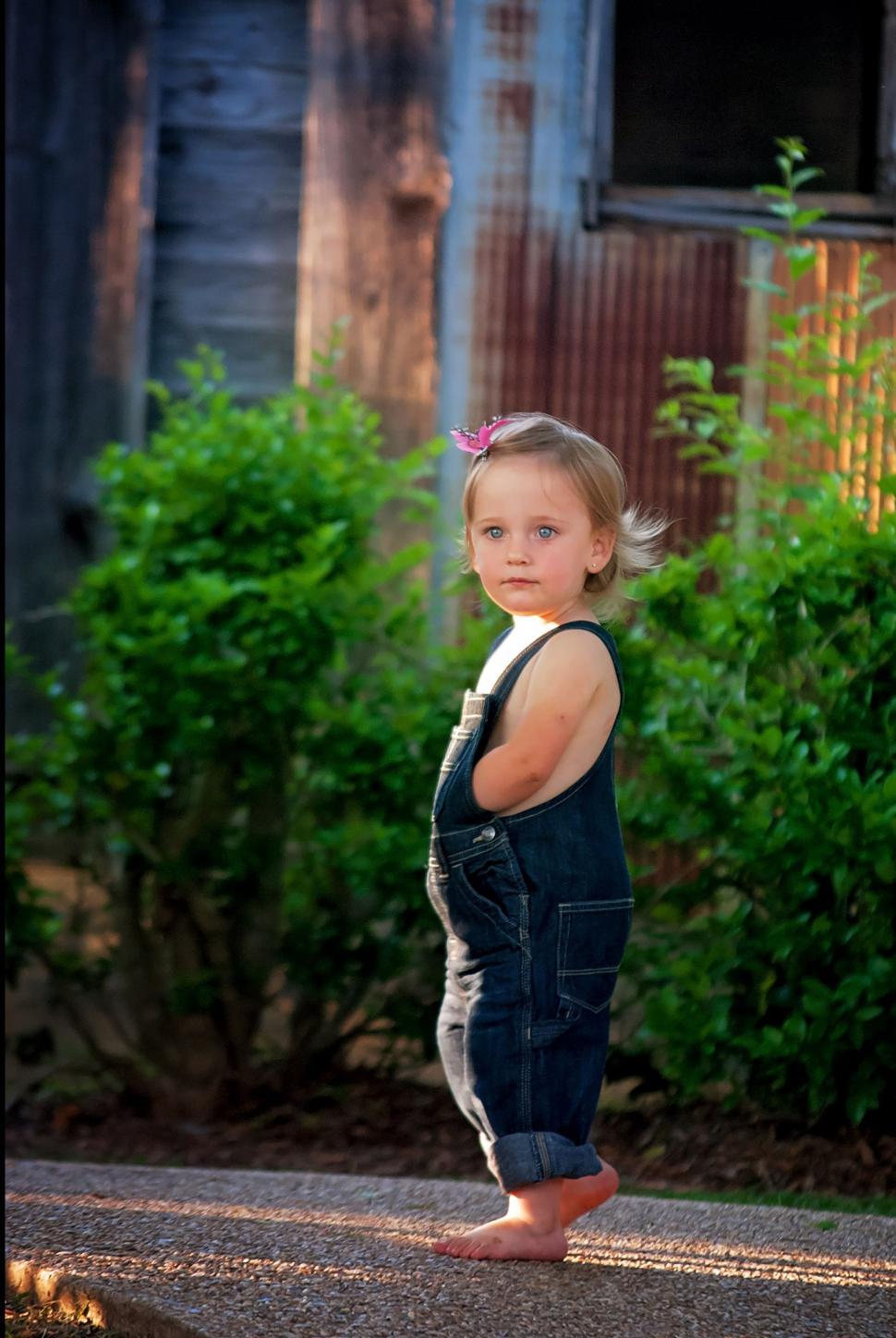 Free Image of Cute Little Girl And Green Plants  