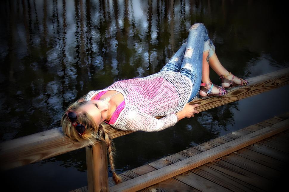 Free Image of Woman Lying on Pier  