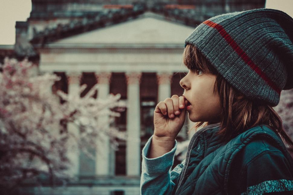 Free Image of Little Boy with thumb in mouth - looking away  