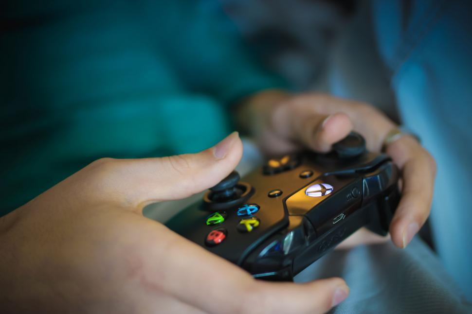 Free Image of Hands and video game controller 