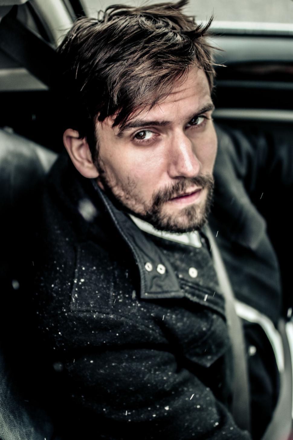 Free Image of Young Male Fashion Model Posing Inside Car 