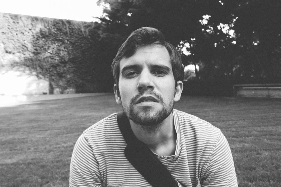 Free Image of Young Man sitting in the park - B&W 