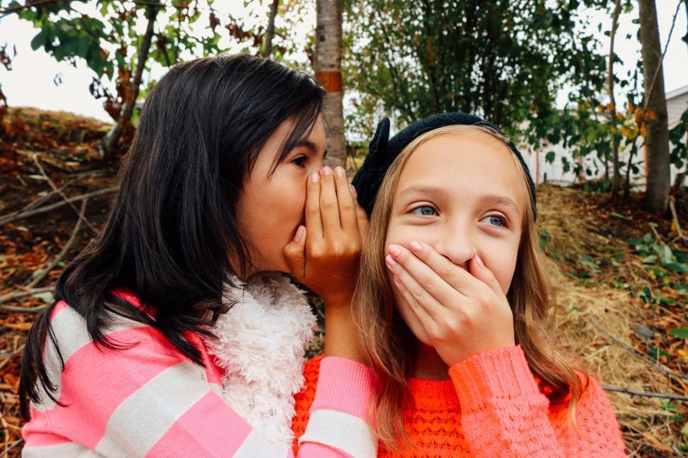 Free Image of Two young girls whispering 