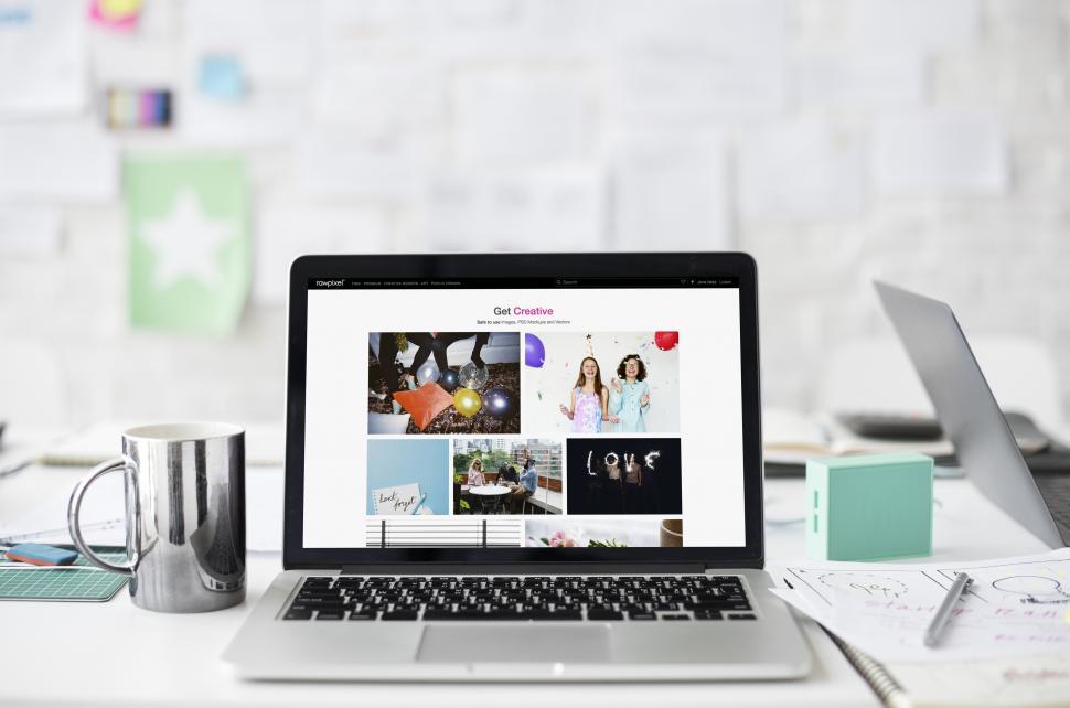 Free Image of A laptop alongside a steel mug on the table 