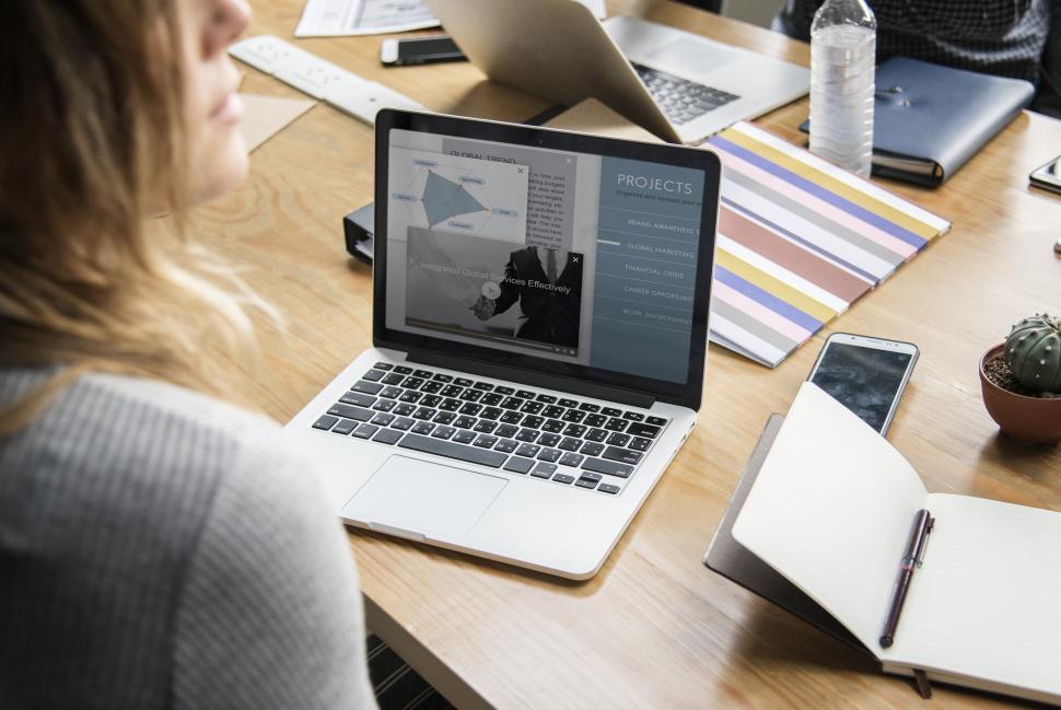 Free Image of Over the shoulder view of a laptop on the table during project meeting 