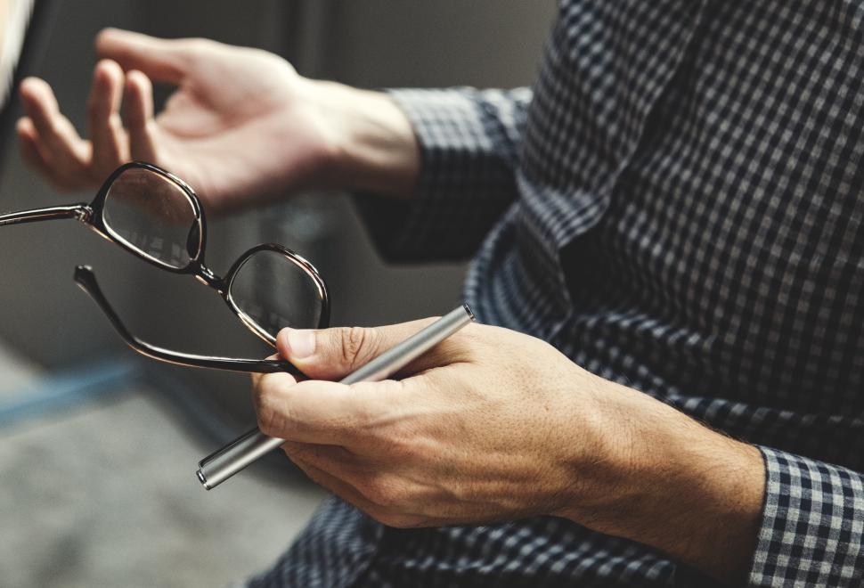 Free Image of Close up of spectacles in a persons hand 