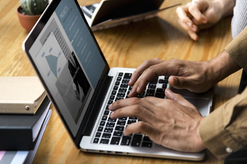 Free Image of Close up of a persons hands typing on a modern laptop 