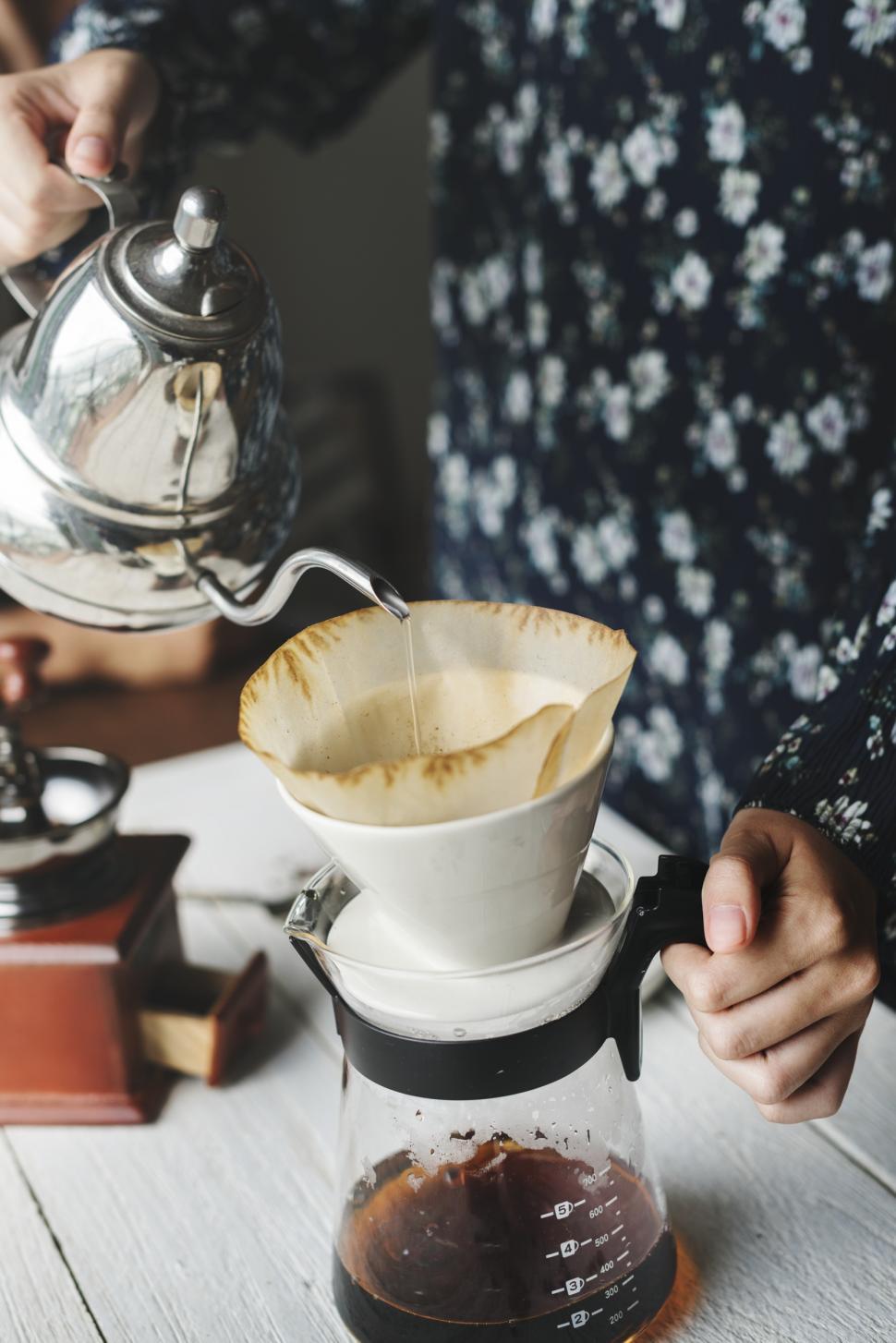Free Image of Close up of hot water being poured over paper coffee filter cone 