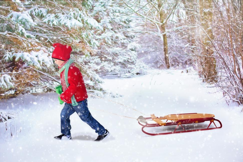 Free Image of Boy pulling sled in snow 