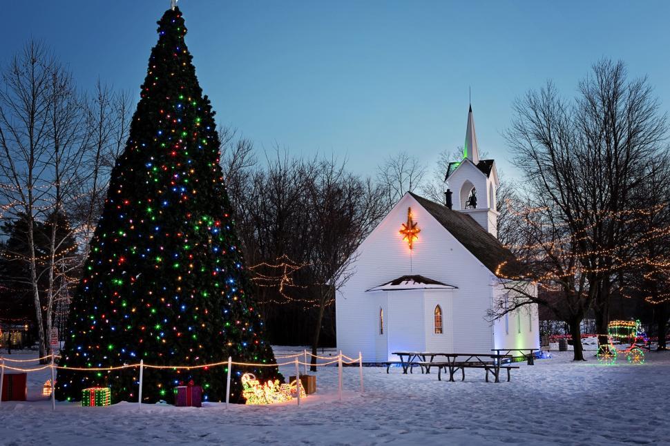 Free Image of Christmas Tree With Colorful Lights and Church  