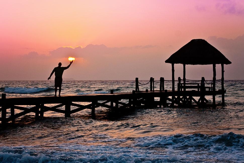 Free Image of Man on Pier at Sunset  