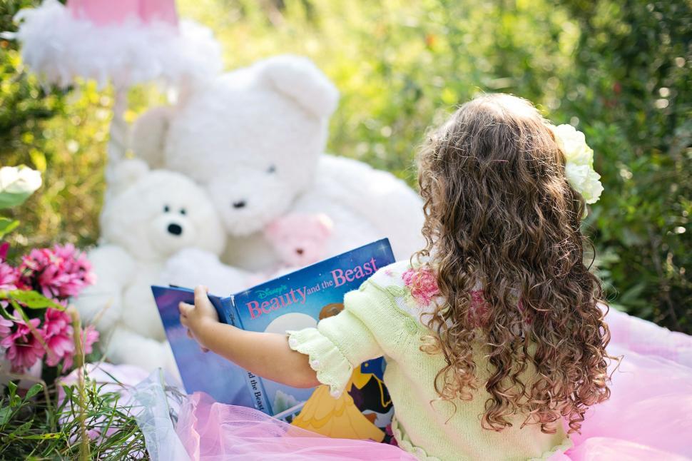 Free Image of Little Girl with book and Teddy Bears in the meadow 
