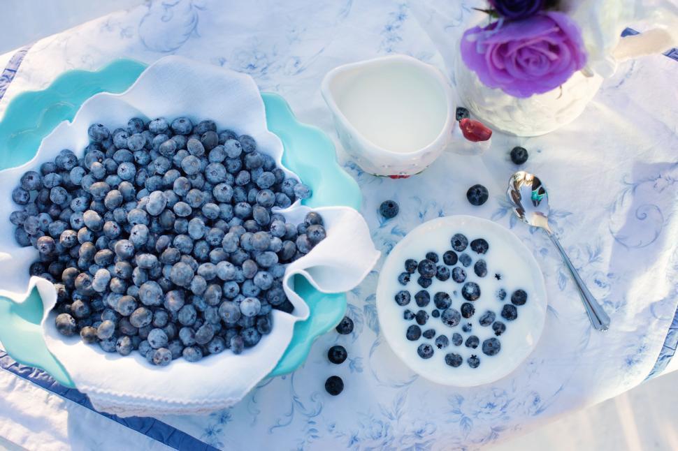 Free Image of Blueberries and purple flower on breakfast table 