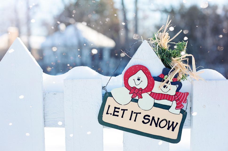 Free Image of Christmas Ornament and Fence in snow  