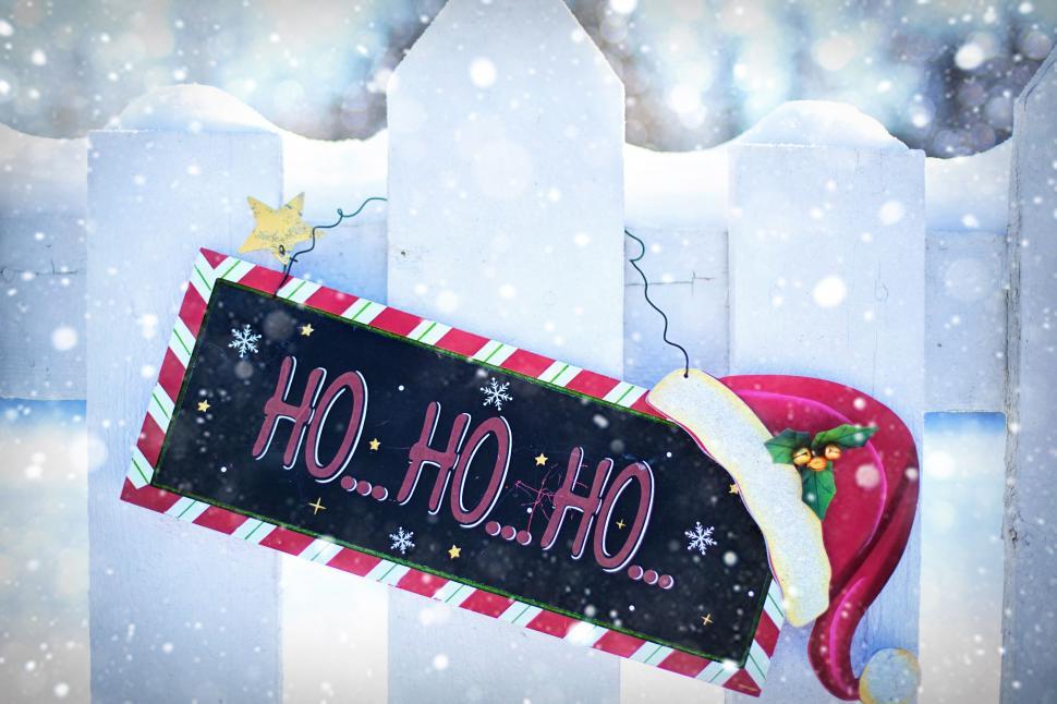 Free Image of Christmas Ornament on white picket fence in snow 