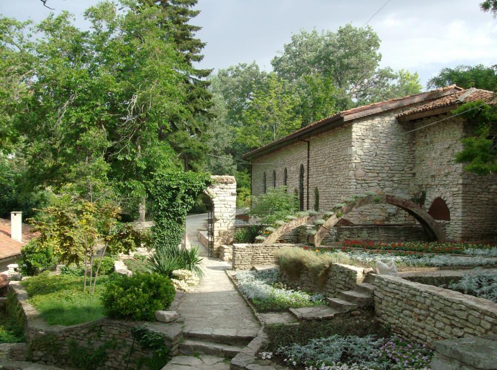Free Image of Small garden with stone alleys full with flowers 