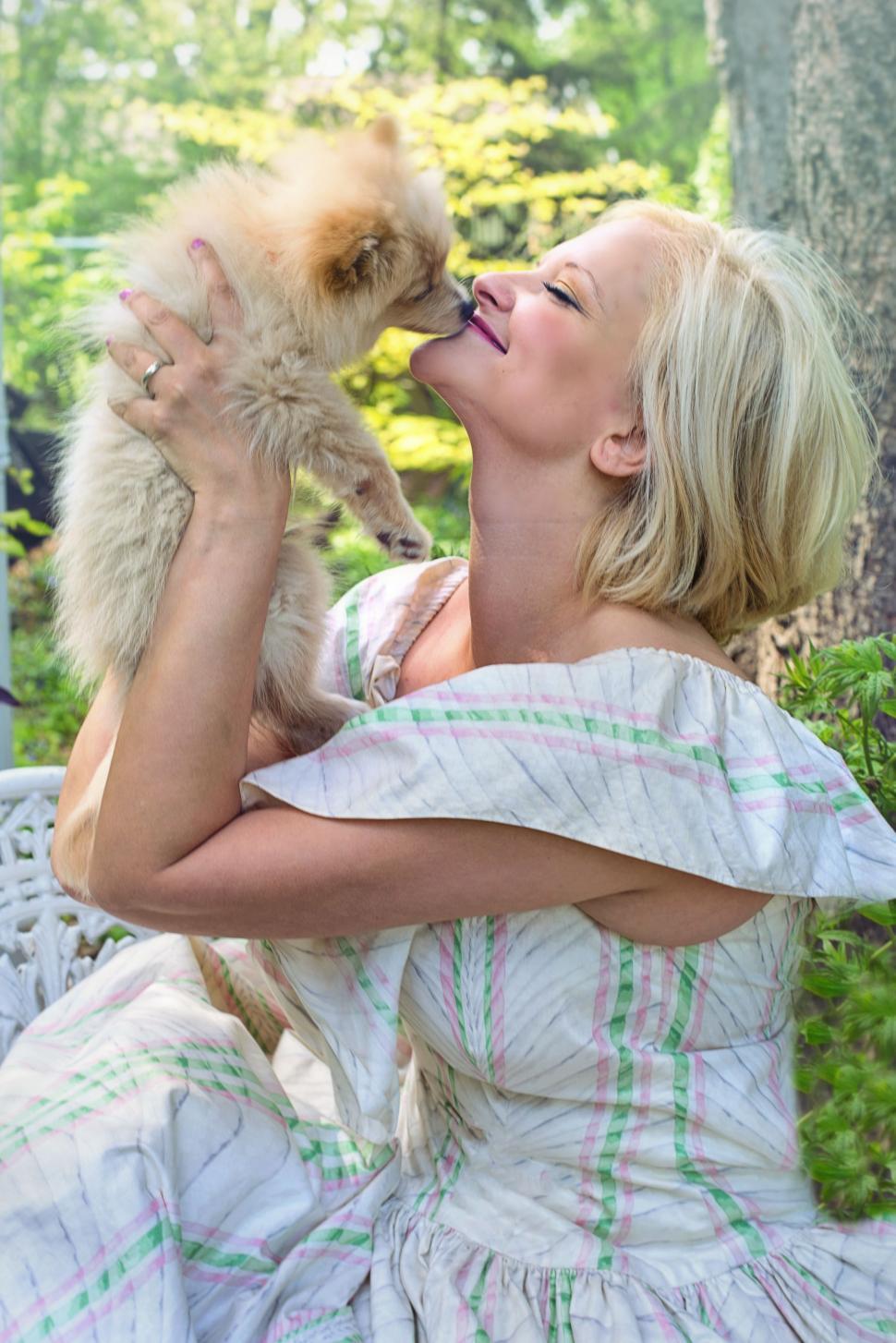 Free Image of Blonde Woman Kissing Dog in the park 