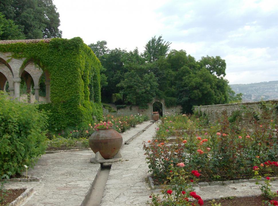Free Image of Small garden with stone alleys full with flowers 