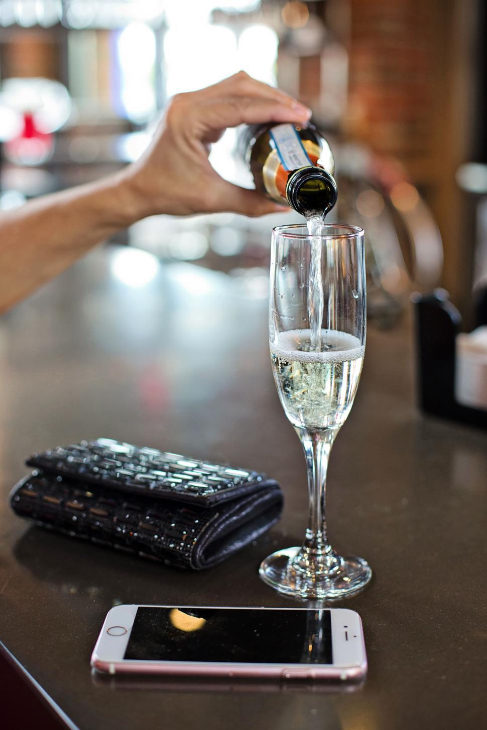 Free Image of Wine Glass and Hand in Bar 