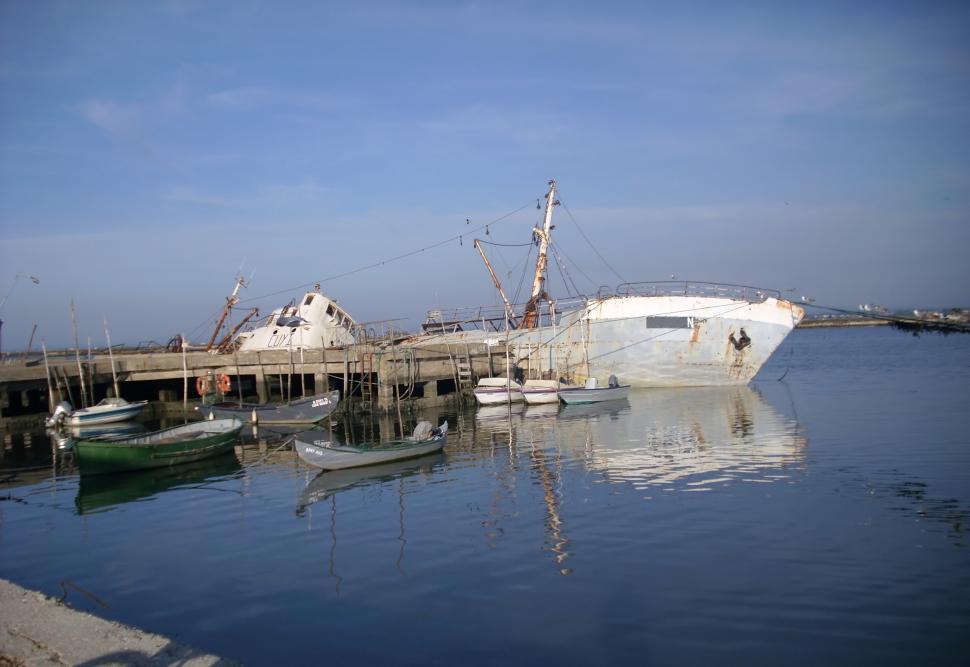 Free Image of Large ships at the dock cloudy sky in the background 