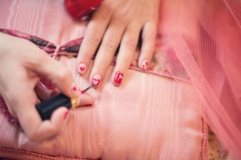 Free Image of Red nail polish on fingers 