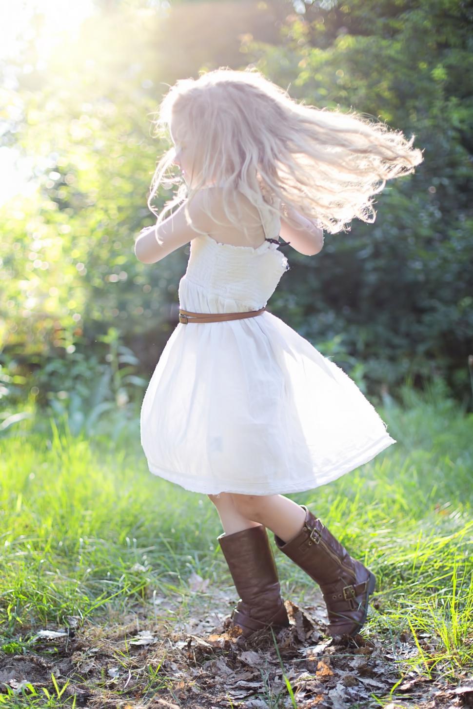 Free Image of Little girl in brown boots in the meadow 