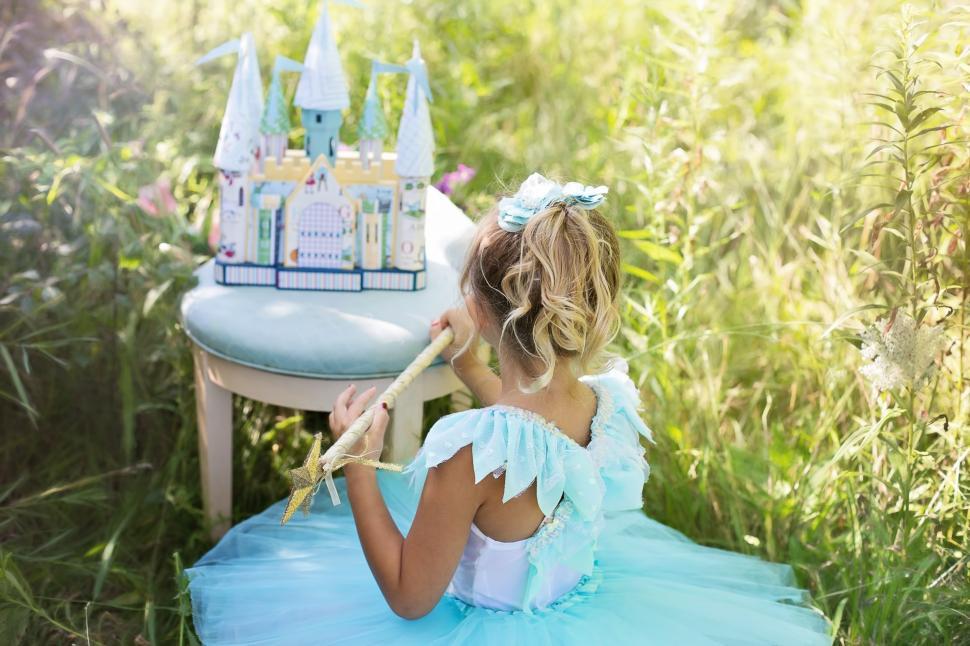 Free Image of Little Girl and Castle Toy in the meadow 