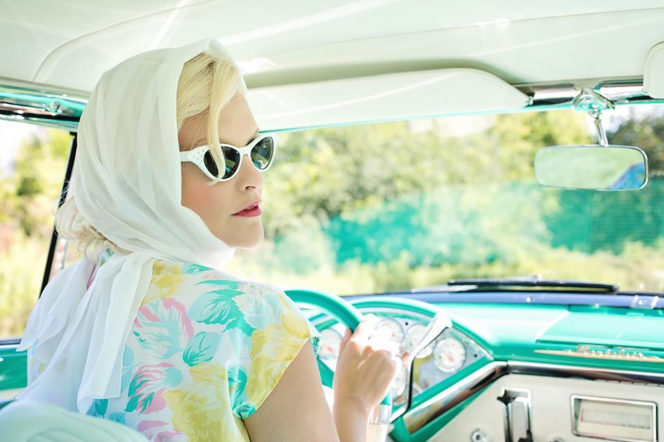 Free Image of Stylish Blonde Woman in Retro Car - Looking Back 