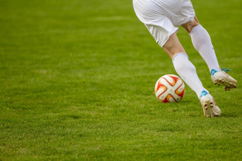 Free Image of Footballer leg running after ball 
