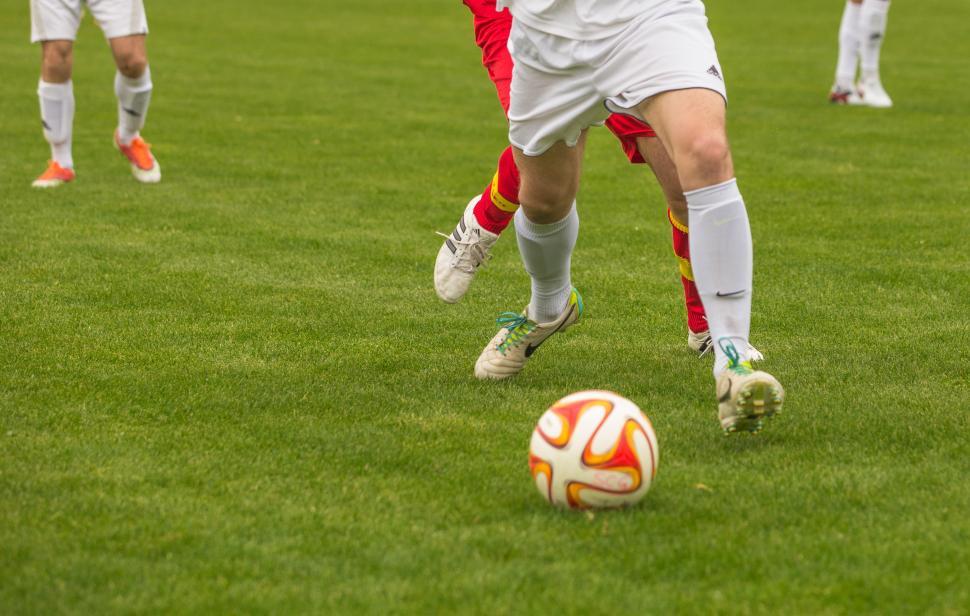 Free Image of Footballers pushing each other for ball 