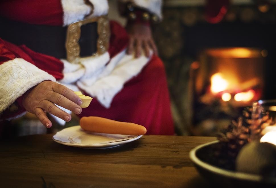Free Image of Santa Claus picking a cookie 