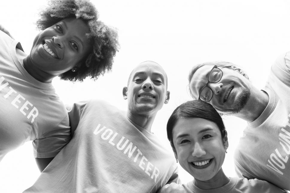 Free Image of Low angle view looking up at a volunteers  huddle in black and white 