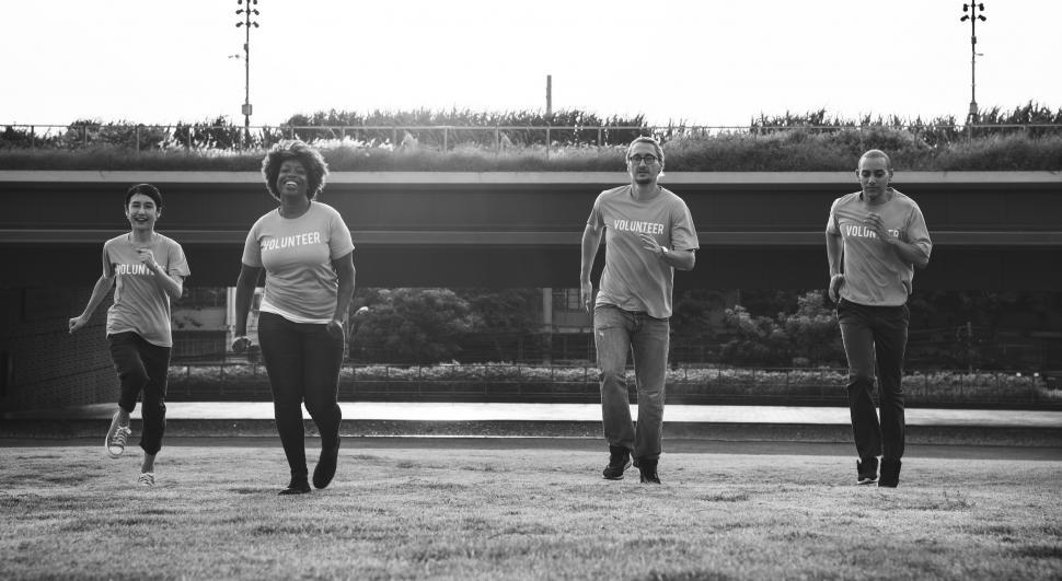 Free Image of A group of multiethnic volunteers running on the grass 