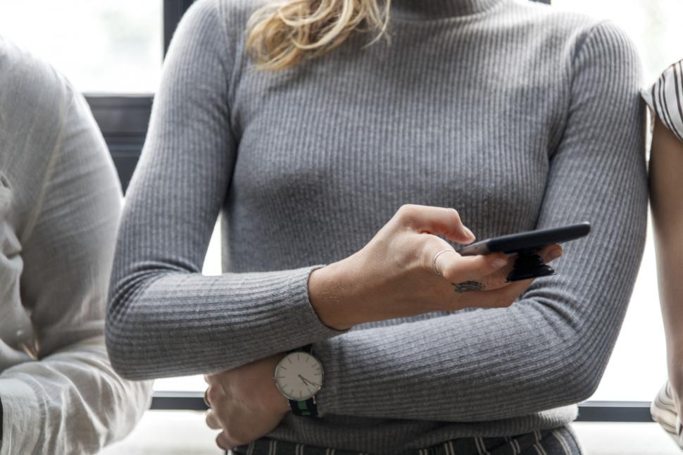 Free Image of Close up of a young woman hand holding mobile phone 