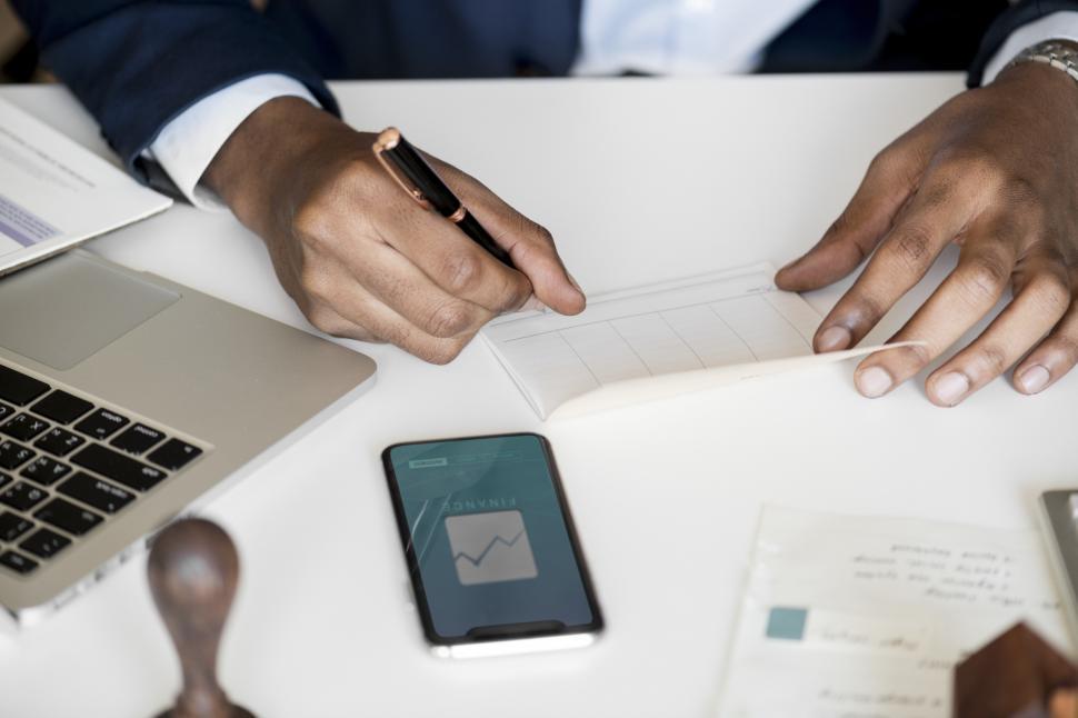 Free Image of Close up of writing on the checkbook while paying bills 