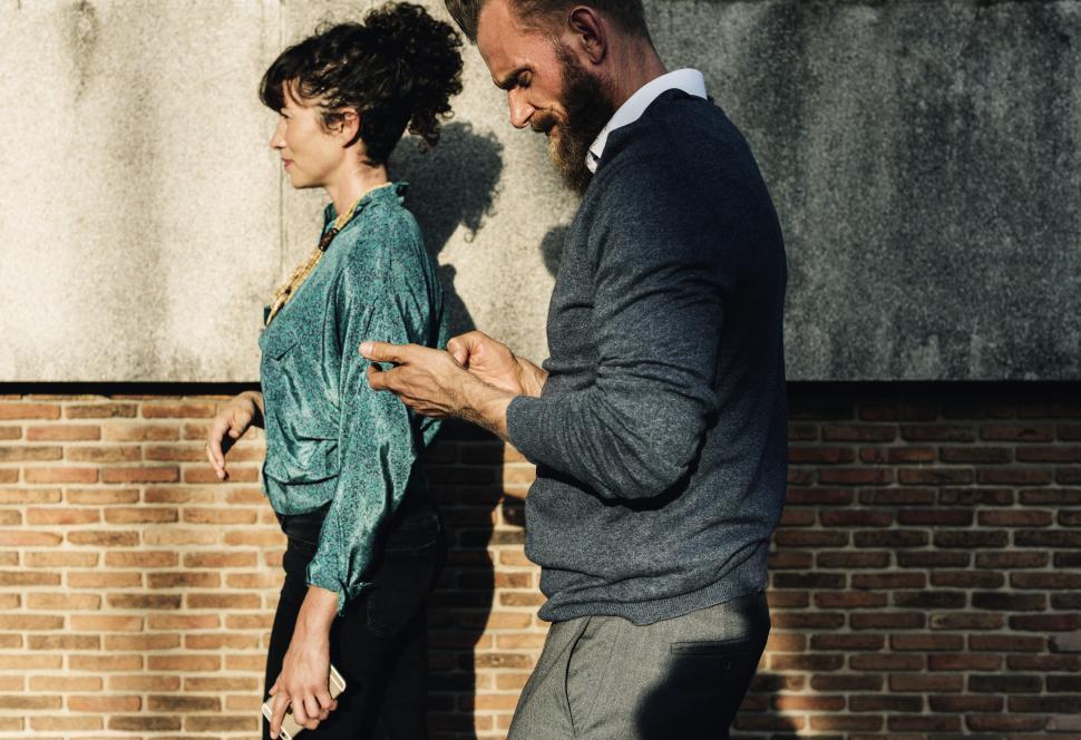 Free Image of Two people discussing while taking a walk 